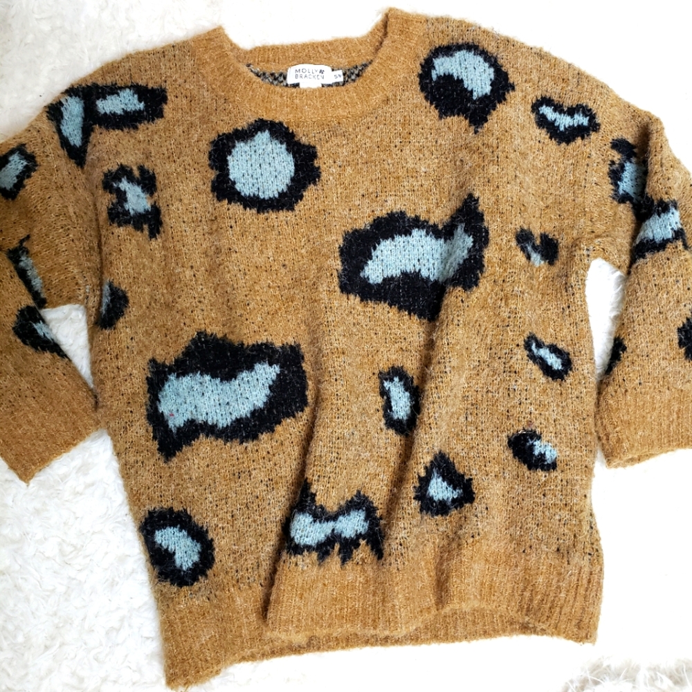 Whimsical sweater from Molly Bracken. Wheat background with blk and mint design.